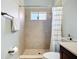 Bathroom featuring walk-in shower with tasteful neutral tiling, vanity, and modern fixtures at 12628 Daisy Pl, Bradenton, FL 34212