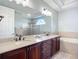 Bright bathroom with double vanity, soaking tub, and a separate glass-enclosed shower at 12628 Daisy Pl, Bradenton, FL 34212
