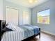 Charming bedroom features light walls, flooring, large window, closet, and a ceiling fan at 12628 Daisy Pl, Bradenton, FL 34212