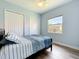 Charming bedroom features light walls, flooring, large window, closet, and a ceiling fan at 12628 Daisy Pl, Bradenton, FL 34212