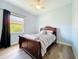 Bedroom features light walls, flooring, large window with curtains, closet, and a ceiling fan at 12628 Daisy Pl, Bradenton, FL 34212