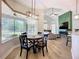Bright dining area with backyard views, stylish lighting, seamlessly connects indoor and outdoor spaces at 12628 Daisy Pl, Bradenton, FL 34212