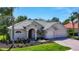 Charming one-story home features a well-manicured lawn, beautiful landscaping, and a three-car garage at 12628 Daisy Pl, Bradenton, FL 34212
