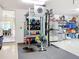 Garage transformed into a home gym with weightlifting equipment and storage racks at 12628 Daisy Pl, Bradenton, FL 34212