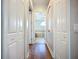 Hallway leading into a large bathroom and featuring ample closet space at 12628 Daisy Pl, Bradenton, FL 34212