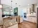 Modern kitchen with granite countertops, stainless steel appliances, and breakfast bar seating at 12628 Daisy Pl, Bradenton, FL 34212