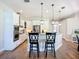 Well-lit kitchen showcases white cabinetry, granite countertops, and sleek stainless steel appliances at 12628 Daisy Pl, Bradenton, FL 34212