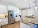 Spacious kitchen with stainless steel refrigerator, granite countertops, and ample cabinet space at 12628 Daisy Pl, Bradenton, FL 34212
