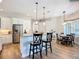 Bright kitchen features a breakfast bar with modern pendant lighting and stainless steel appliances at 12628 Daisy Pl, Bradenton, FL 34212