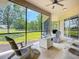 Relaxing screened lanai with outdoor seating and a fire pit, overlooking a lush green lawn at 12628 Daisy Pl, Bradenton, FL 34212