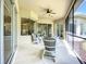 Relaxing screened lanai with ceiling fan, outdoor seating, and views of the backyard at 12628 Daisy Pl, Bradenton, FL 34212