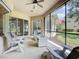 Cozy screened lanai with comfortable seating, fire table, and views of the landscaped yard at 12628 Daisy Pl, Bradenton, FL 34212