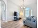 Modern living room with a media center, large window and a comfortable sofa at 12628 Daisy Pl, Bradenton, FL 34212