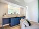 Cozy living room featuring a custom-built blue cabinet with a wooden countertop, complementing the neutral decor at 12628 Daisy Pl, Bradenton, FL 34212