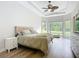 Bright main bedroom with tray ceilings, large windows offering scenic views, and stylish furnishings at 12628 Daisy Pl, Bradenton, FL 34212