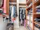 Organized walk-in closet featuring custom wood shelving and plenty of storage space for clothes and accessories at 12628 Daisy Pl, Bradenton, FL 34212
