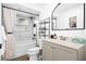 Bright bathroom with a shower/tub combo, modern vanity, and black fixtures for a sleek design at 1311 Cypress Ave, Venice, FL 34285