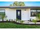Inviting front door with decorative glass and manicured landscaping at 1311 Cypress Ave, Venice, FL 34285