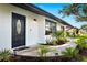 Inviting front door with decorative glass and manicured landscaping at 1311 Cypress Ave, Venice, FL 34285