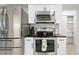 Kitchen with stainless steel appliances, white cabinetry, and a view into an adjacent pantry at 1311 Cypress Ave, Venice, FL 34285