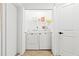 Efficient laundry area with a washer, dryer and closet doors for extra storage at 1311 Cypress Ave, Venice, FL 34285