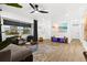 Bright living room with wood floors and a large flat screen TV at 1311 Cypress Ave, Venice, FL 34285