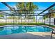Backyard pool featuring screened enclosure, green grass, and shed at 1311 Cypress Ave, Venice, FL 34285