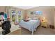 Bright bedroom with large windows, comfortable bed, and a view of the outdoors at 1343 Glendale W Cir # 216, Sarasota, FL 34232