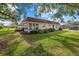 Attractive home surrounded by green lawn, trees, and plantings under a sunny sky at 1343 Glendale W Cir # 216, Sarasota, FL 34232