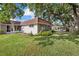 Charming home with lush landscaping and mature trees, featuring a well-manicured lawn at 1343 Glendale W Cir # 216, Sarasota, FL 34232