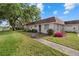 Charming home with a walkway, lush lawn, and colorful landscaping enhancing its appeal at 1343 Glendale W Cir # 216, Sarasota, FL 34232