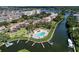 Aerial view of the waterfront condos showing the community pool, boat docks and landscaping at 1500 Cove Ii Pl # 524, Sarasota, FL 34242