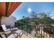 Balcony overlooking a garden area featuring seating area, railing, and shade from trees at 1500 Cove Ii Pl # 524, Sarasota, FL 34242