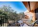 View from balcony with patio furniture overlooking green space filled with trees at 1500 Cove Ii Pl # 524, Sarasota, FL 34242