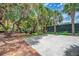 Community basketball court with mature trees and lush landscaping at 1500 Cove Ii Pl # 524, Sarasota, FL 34242