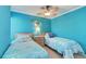 Bedroom with two twin beds, blue walls, and mermaid decor at 1500 Cove Ii Pl # 524, Sarasota, FL 34242