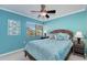 Bedroom with blue walls, large window, and a wicker-style queen bed at 1500 Cove Ii Pl # 524, Sarasota, FL 34242