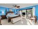 Main bedroom with private balcony, four-poster bed, and comfortable seating for relaxation and enjoyment at 1500 Cove Ii Pl # 524, Sarasota, FL 34242