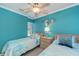 Bedroom with two twin beds, blue walls, and mermaid decor at 1500 Cove Ii Pl # 524, Sarasota, FL 34242