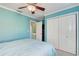 Bedroom with blue walls, double closets, and an open doorway at 1500 Cove Ii Pl # 524, Sarasota, FL 34242