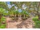 Exterior view of the clubhouse surrounded by lush tropical landscaping at 1500 Cove Ii Pl # 524, Sarasota, FL 34242