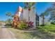 Well maintained condo building with manicured landscaping and bright blue sky at 1500 Cove Ii Pl # 524, Sarasota, FL 34242