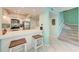Open kitchen with breakfast bar, stainless steel appliances, white cabinetry and stairs to the next level at 1500 Cove Ii Pl # 524, Sarasota, FL 34242
