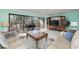 Bright living room with balcony access, comfortable seating, and a large entertainment center with mounted television at 1500 Cove Ii Pl # 524, Sarasota, FL 34242