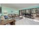 Bright living room with sliding glass doors to the lanai and neutral decor at 1500 Cove Ii Pl # 524, Sarasota, FL 34242