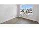 Minimalist bedroom featuring wood-look floors and a large window with neighborhood views at 1620 Sea Haven Dr # 404, Punta Gorda, FL 33950