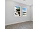 Bedroom featuring light wood floors and two large windows at 1620 Sea Haven Dr # 404, Punta Gorda, FL 33950