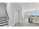 Bright entryway featuring a staircase and an open layout leading into the kitchen area at 1620 Sea Haven Dr # 404, Punta Gorda, FL 33950