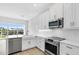 Modern kitchen featuring stainless steel appliances, sleek countertops, and ample natural light at 1620 Sea Haven Dr # 404, Punta Gorda, FL 33950