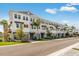 Row of stylish gray townhomes featuring private garages, elegant shutters, and well-maintained landscaping along a pristine street at 1620 Sea Haven Dr # 404, Punta Gorda, FL 33950
